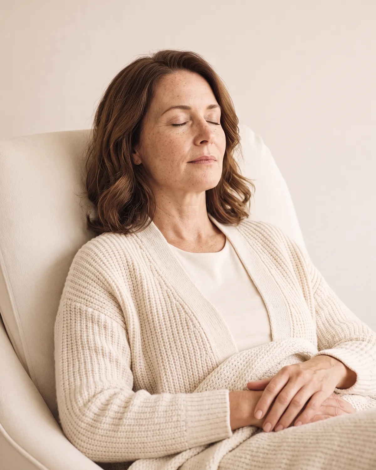Woman resting with eyes closed in a recliner during ketamine therapy in Vero Beach