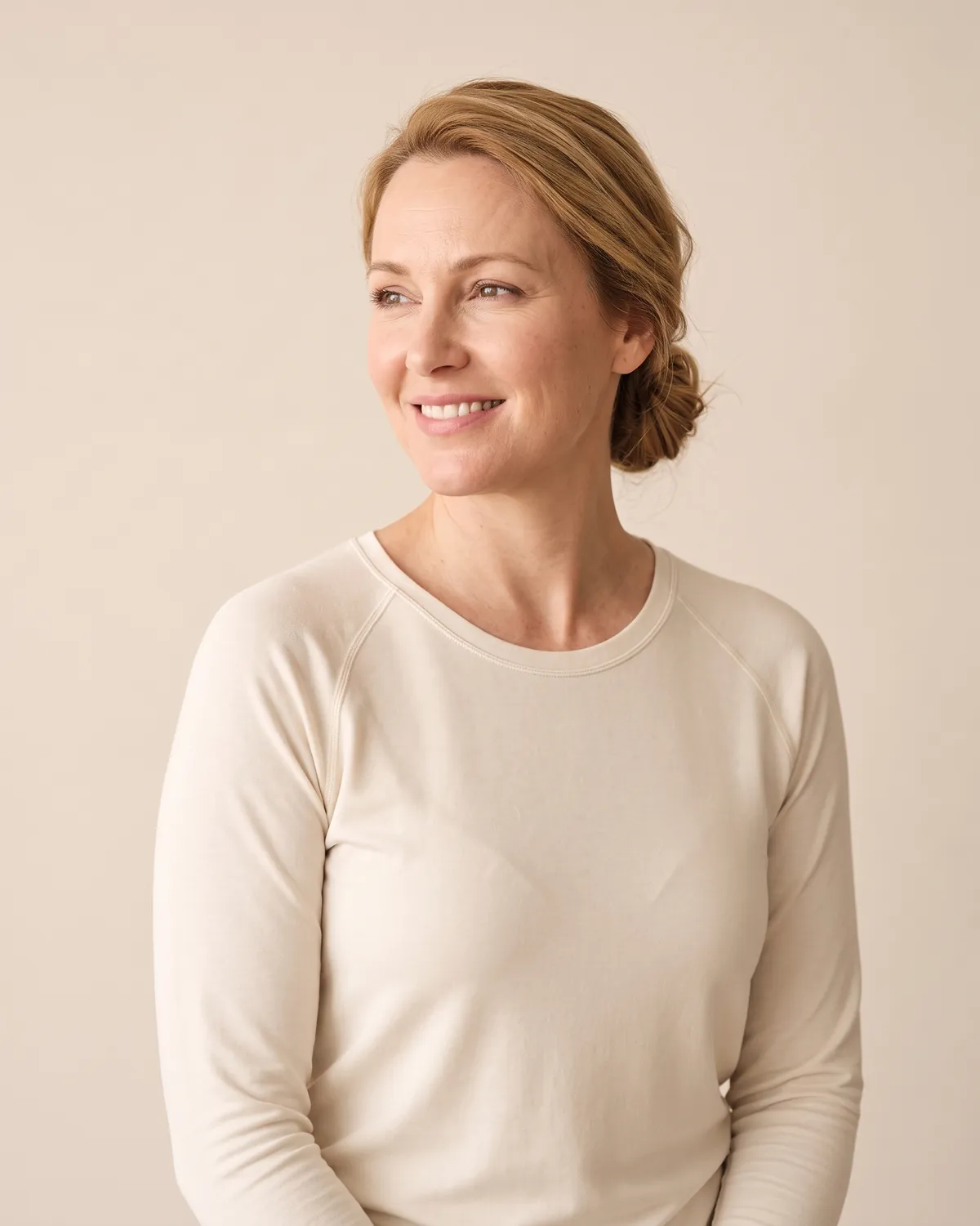 Smiling woman in a cream top at a medical weight loss visit in Vero Beach